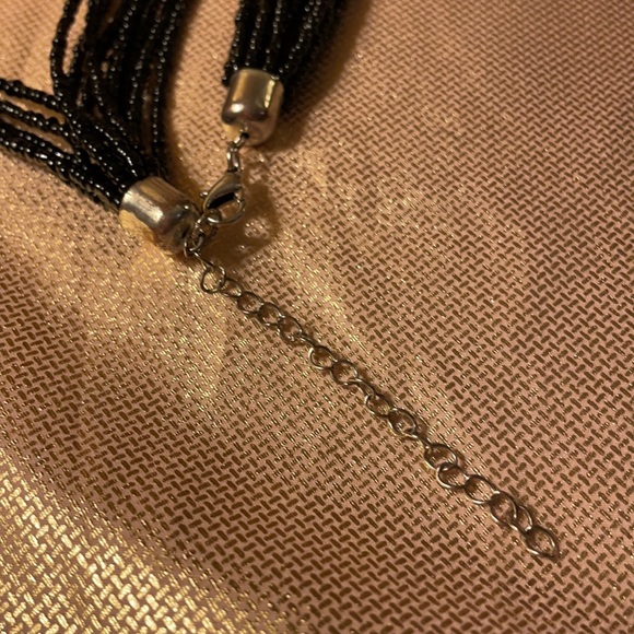 Black multi stranded beaded necklace with silver cross pendant. - Picture 6 of 6